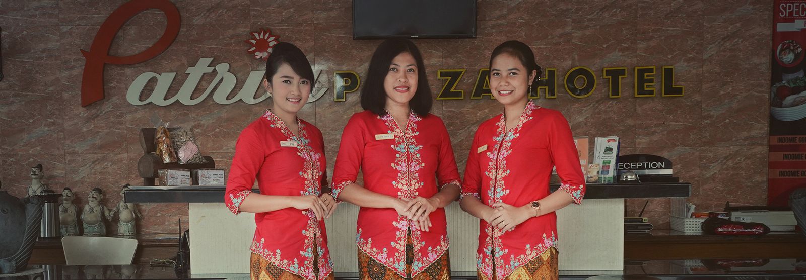 Front desk staff in kebaya at Patria Plaza Hotel